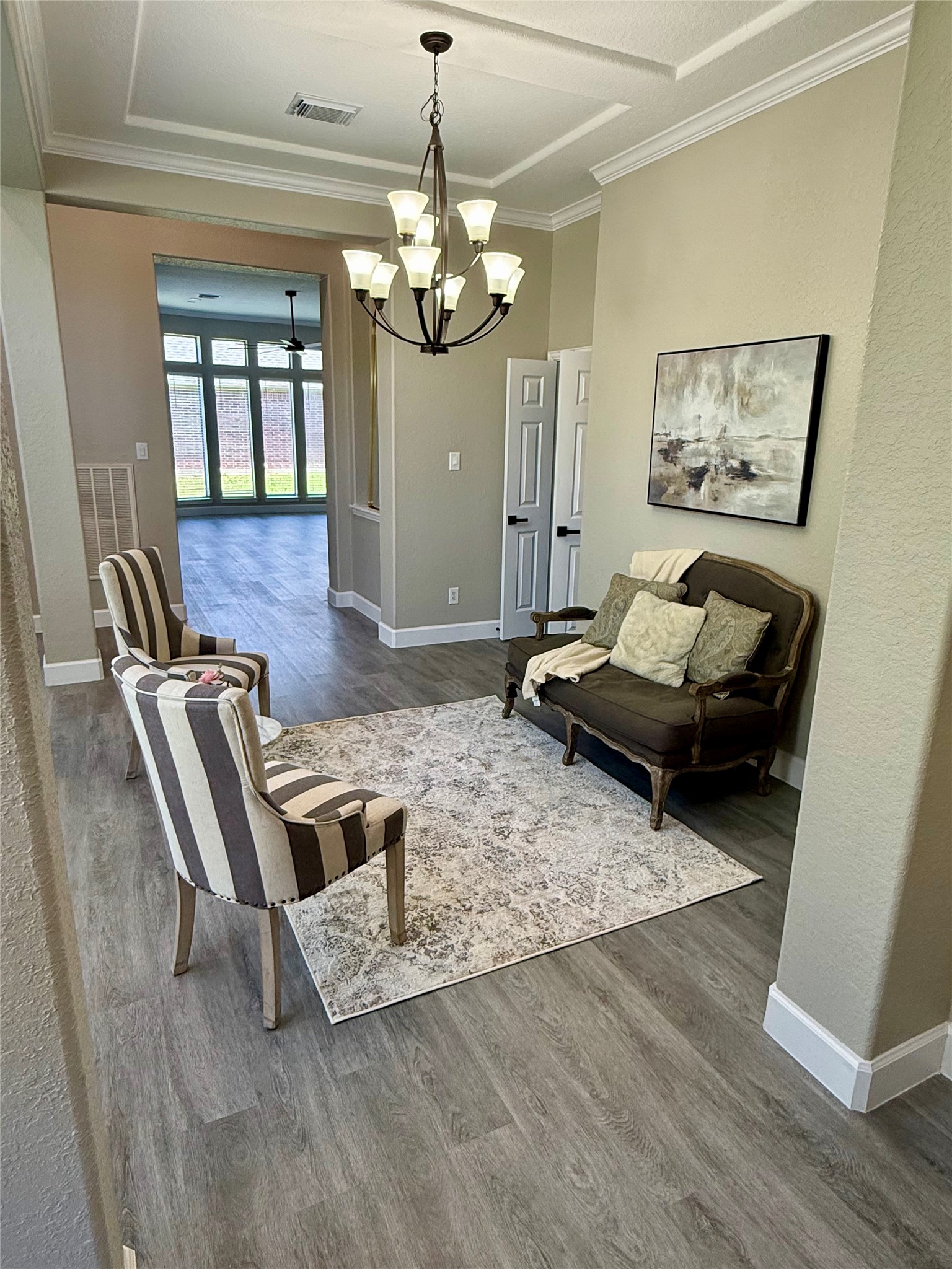 7218 Spring Meadow Lane Katy, TX 77494 - Photo 5 of 30 a living room with furniture and a chandelier