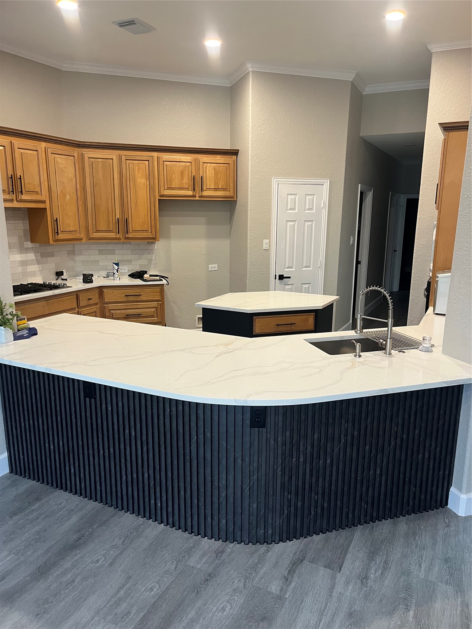 7218 Spring Meadow Lane Katy, TX 77494 - Photo 9 of 30 a kitchen with stainless steel appliances wooden cabinets a sink and a wooden floor
