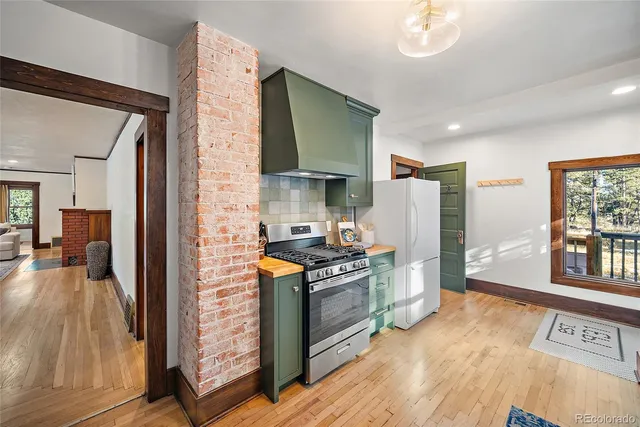 a kitchen with stainless steel appliances granite countertop a stove and a refrigerator