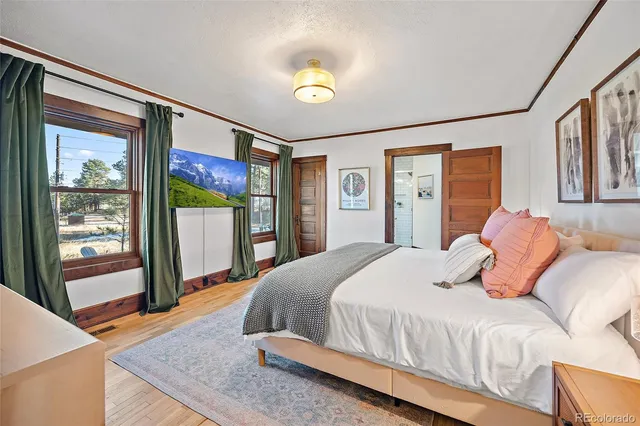 a bedroom with a bed and glass door