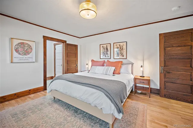 a bedroom with a large bed and a chandelier