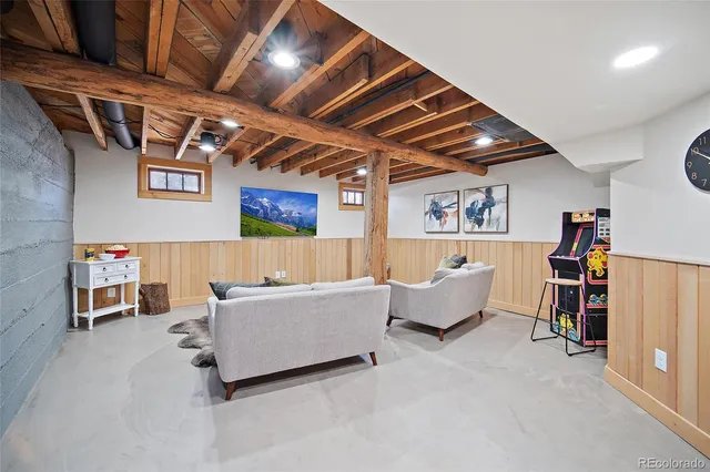 a living room with furniture and a gym machine