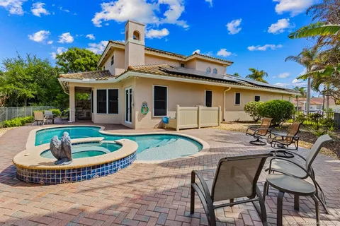 a view of a house with swimming pool and sitting area