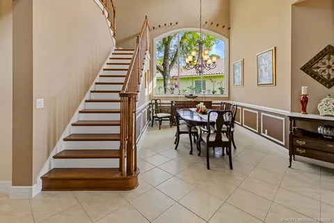 a view of a patio with a table chairs and a backyard