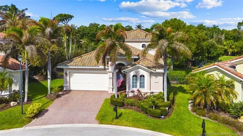 an aerial view of a house with a yard and outdoor seating