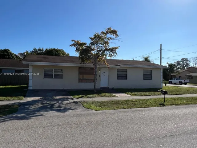 a front view of a house with a yard and a garage