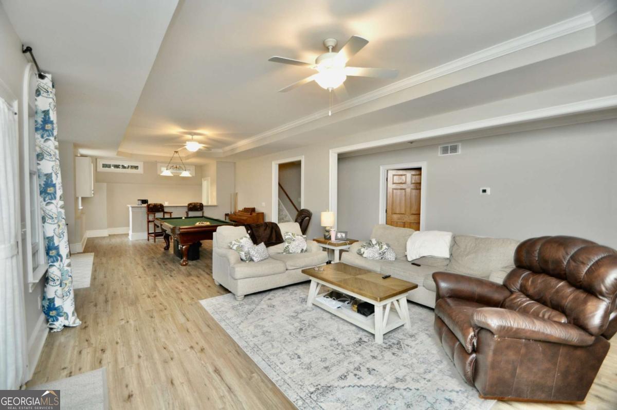 1070 Lexington Court Bishop, GA 30621 - Photo 47 of 67 a living room with furniture couches and a dining table with wooden floor