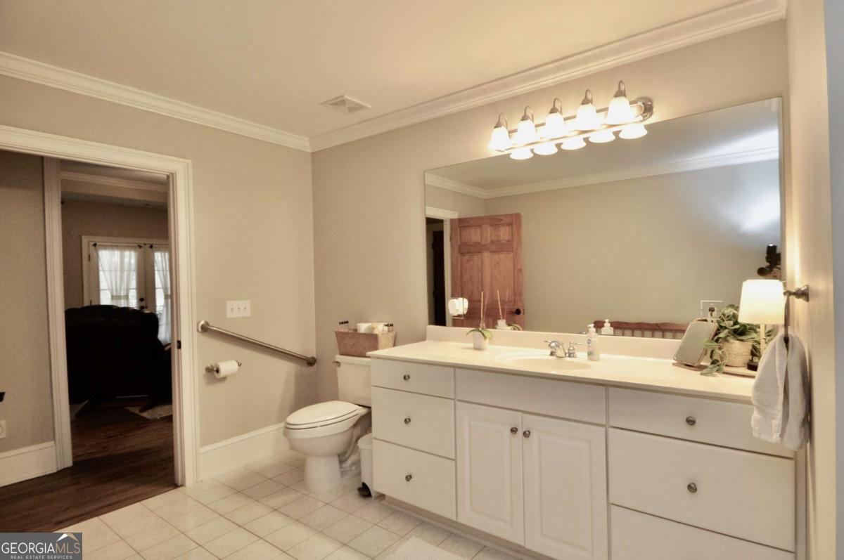 1070 Lexington Court Bishop, GA 30621 - Photo 55 of 67 a spacious bathroom with a double vanity sink mirror and toilet