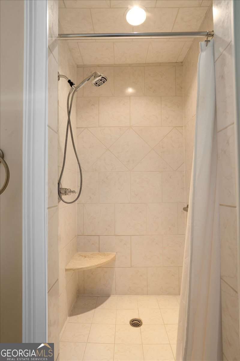 1070 Lexington Court Bishop, GA 30621 - Photo 56 of 67 a bathroom with a shower and a glass door