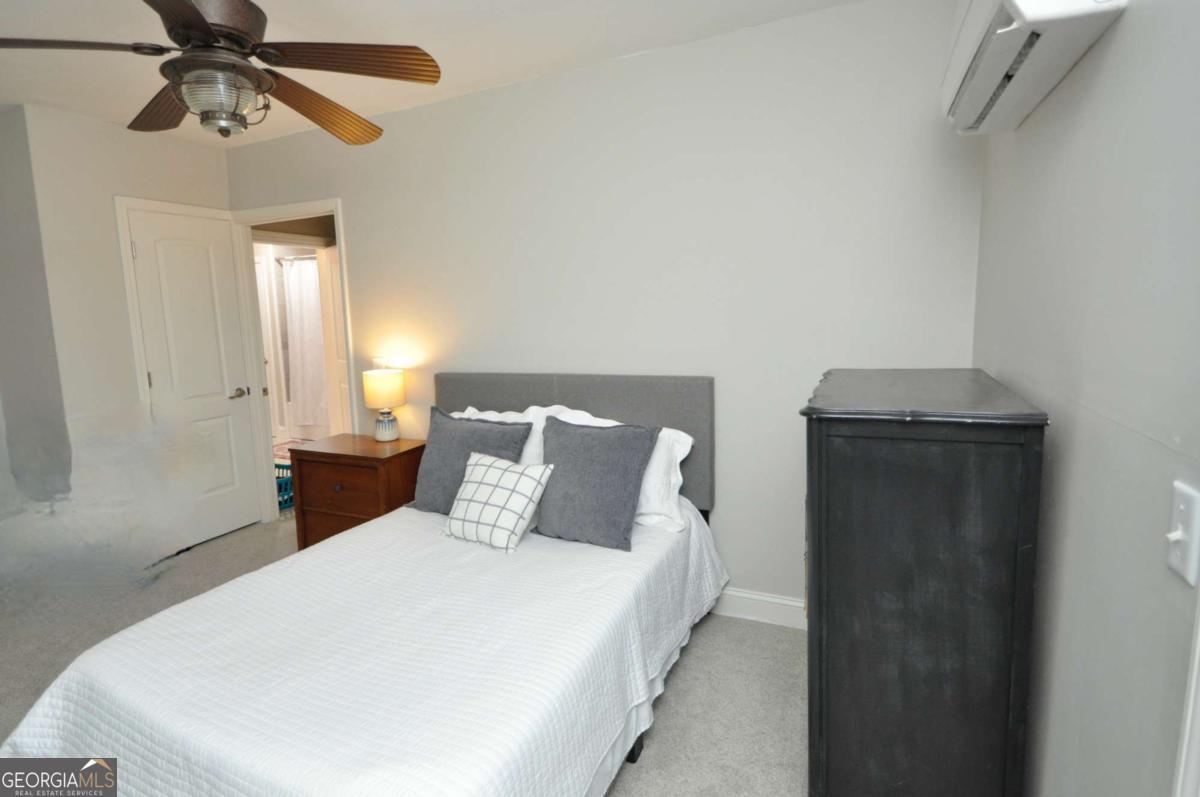 1070 Lexington Court Bishop, GA 30621 - Photo 59 of 67 a bedroom with a bed and a chandelier