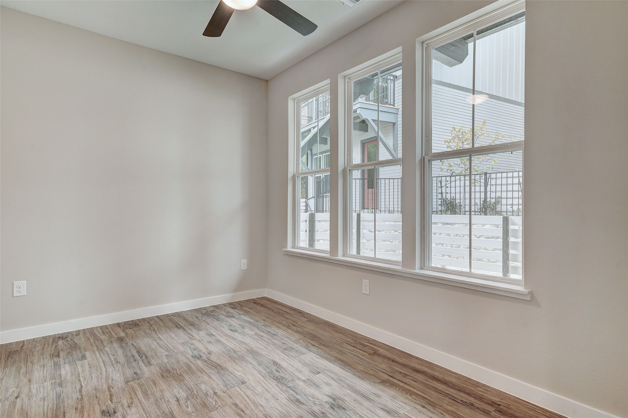 3809 Valley View Road, Unit 13 Austin, TX 78704 - Photo 5 of 27 an empty room with wooden floor and windows