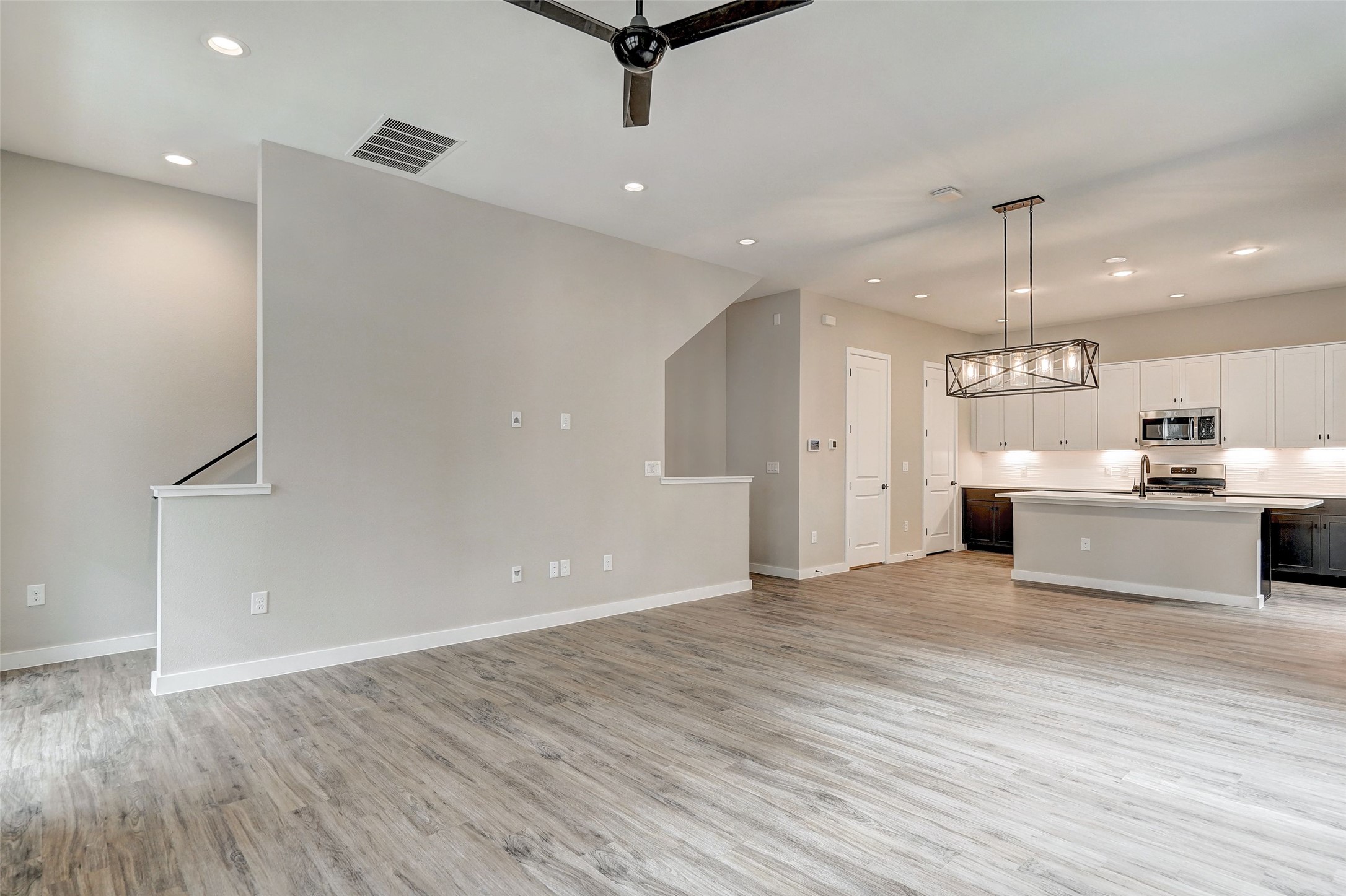 3809 Valley View Road, Unit 13 Austin, TX 78704 - Photo 27 of 27 a view of a kitchen with kitchen island a sink wooden floor and a refrigerator