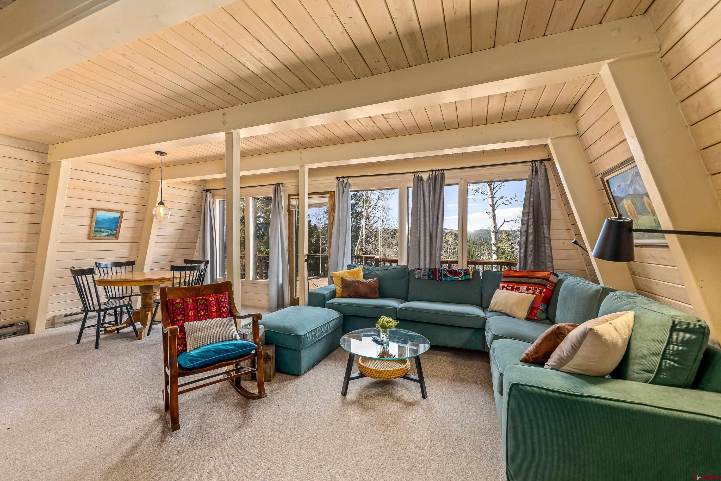 771 Spruce Road Cimarron, CO 81220 - Photo 11 of 34 a living room with furniture and a potted plant