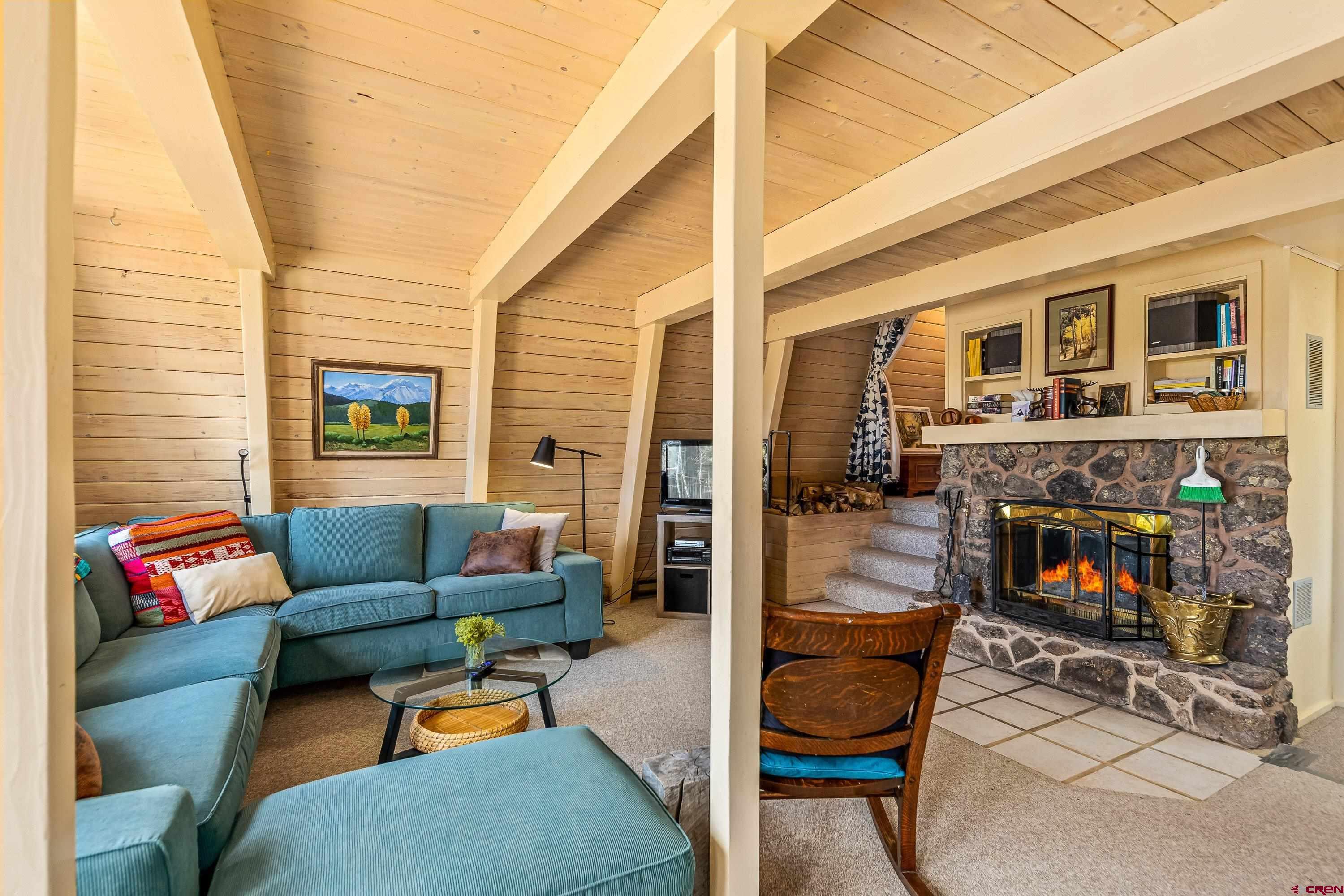 771 Spruce Road Cimarron, CO 81220 - Photo 14 of 34 a living room with fireplace furniture and a fireplace