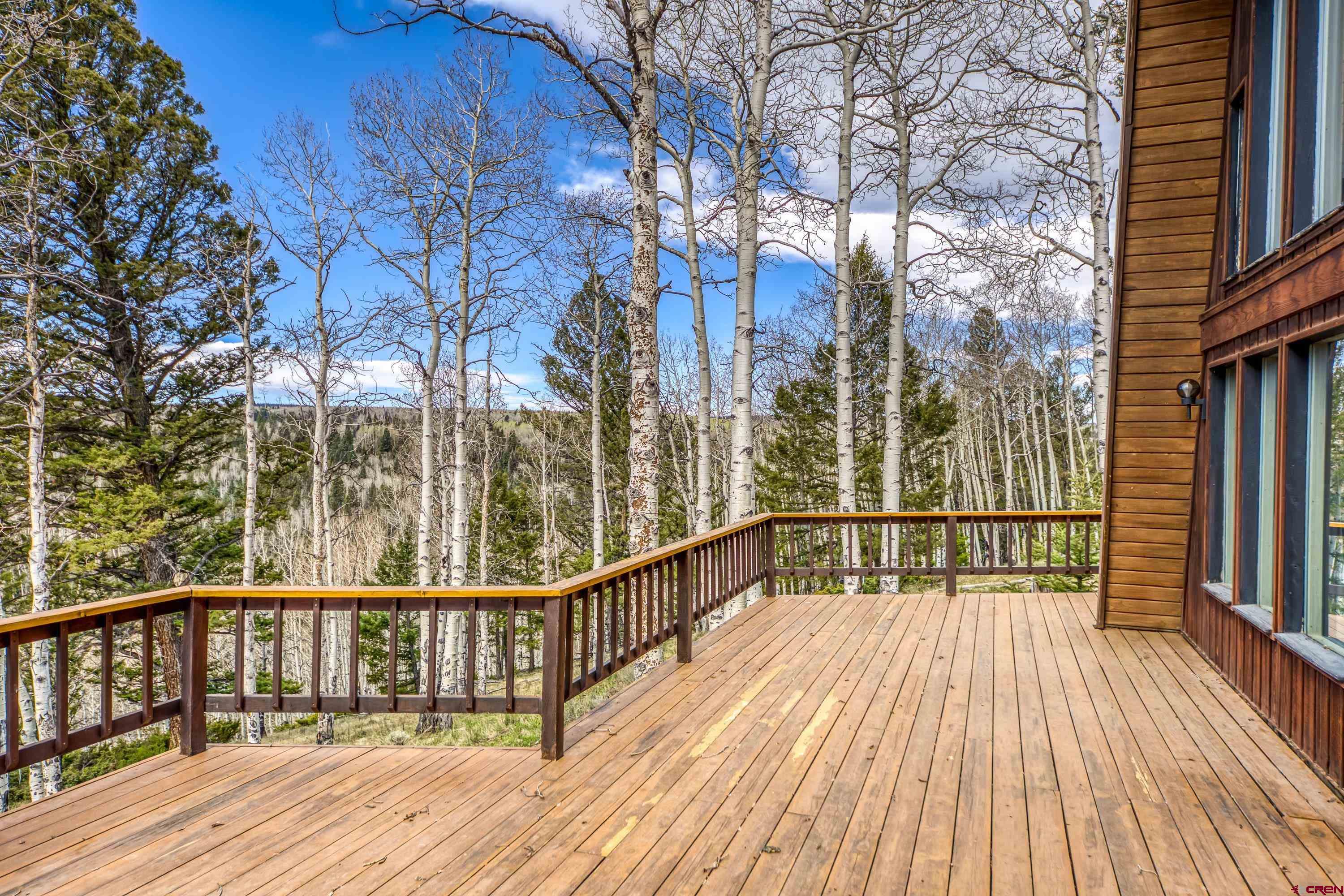 771 Spruce Road Cimarron, CO 81220 - Photo 23 of 34 a view of a balcony with wooden floor and fence
