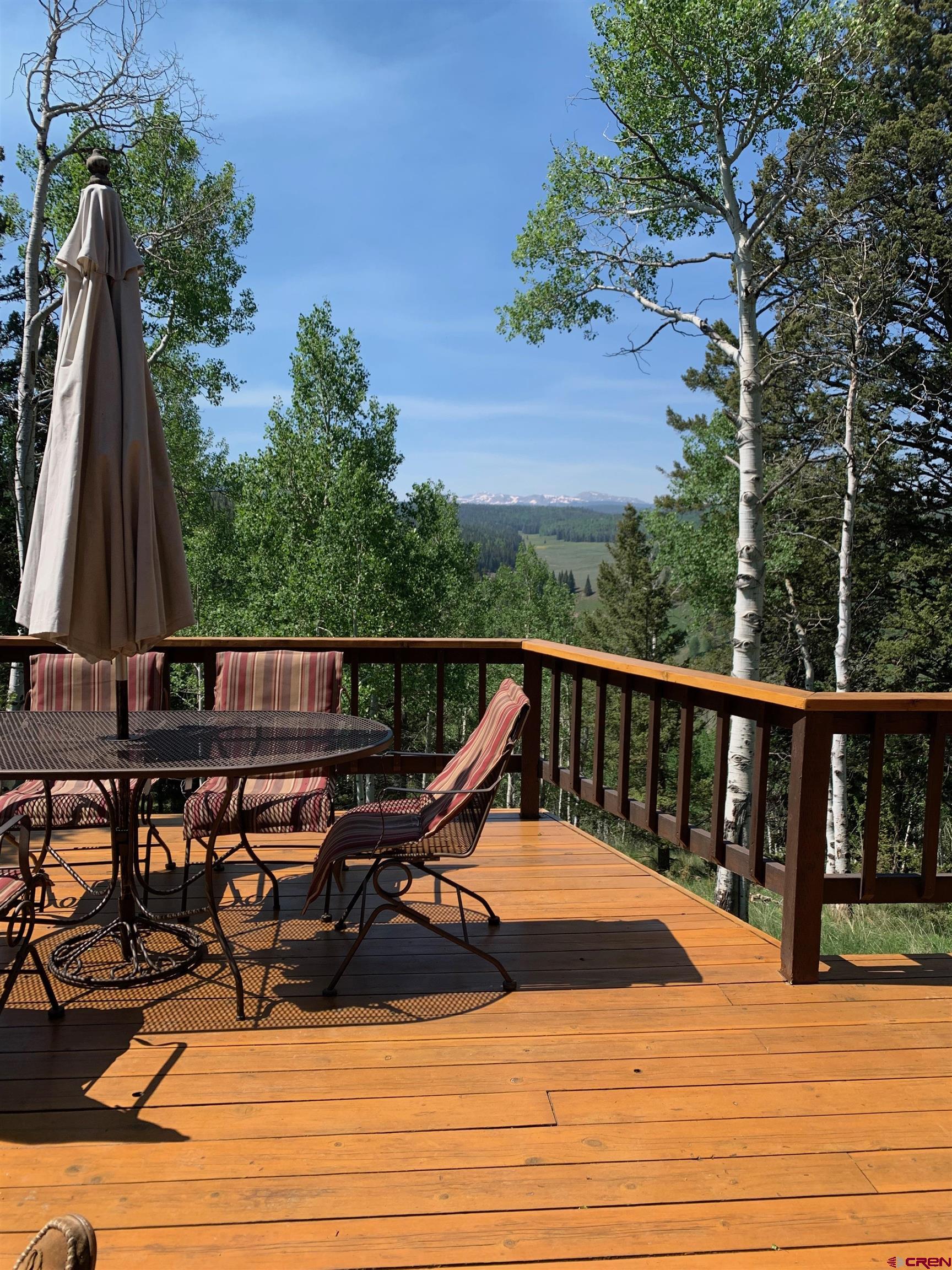 771 Spruce Road Cimarron, CO 81220 - Photo 3 of 34 a view of a balcony with chairs and wooden fence