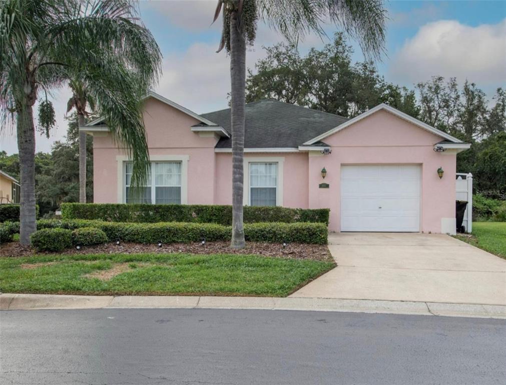 a front view of house with yard and green space
