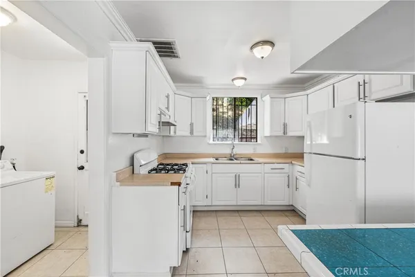 a kitchen with a refrigerator a sink and dishwasher
