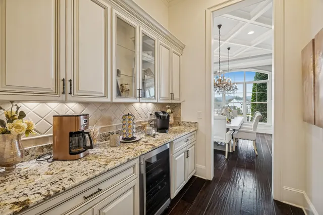 a kitchen with stainless steel appliances granite countertop a kitchen island hardwood floor sink and cabinets