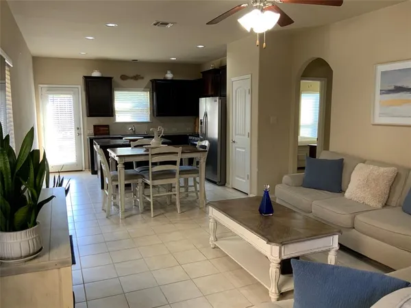 a bedroom with a bed and a ceiling fan