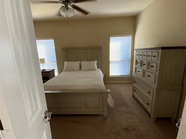 a bedroom with a bed and a television
