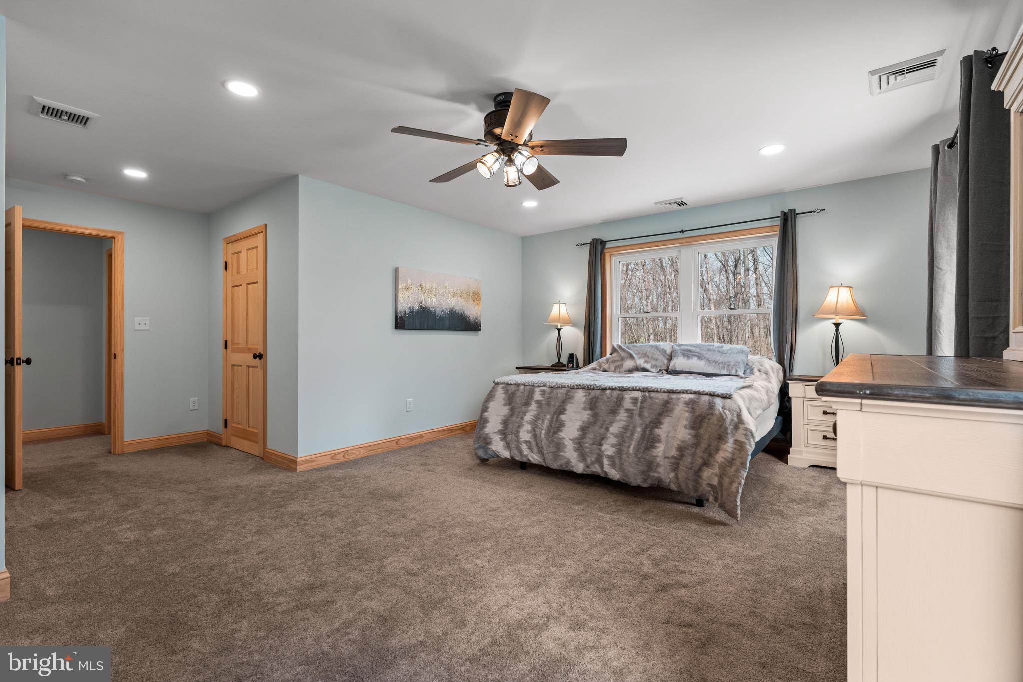 51 Hausman Road Lenhartsville, PA 19534 - Photo 51 of 64 a bedroom with a large bed chandelier and a window