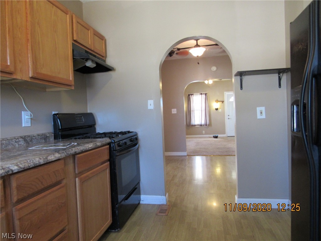 Looking toward the front of the house  from the kitchen. To the right is the refrigerator and there's also a pantry cupboard next to the refrigerator.