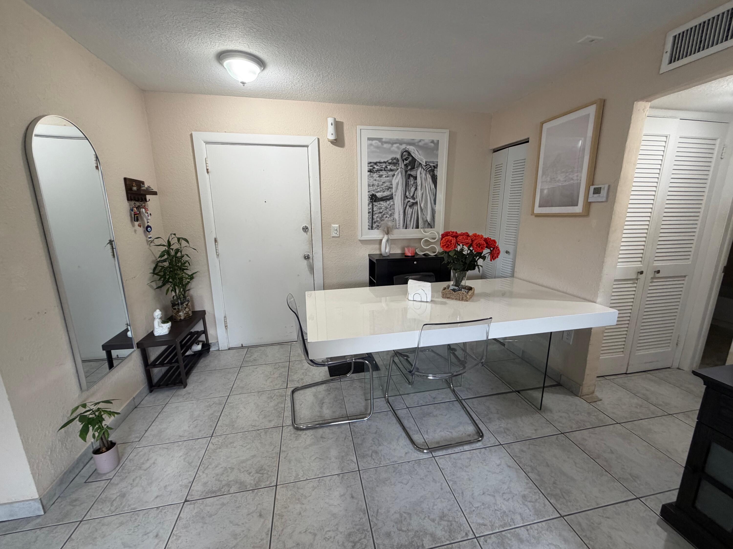 4841 Northwest 7th Street, Unit 3084 Miami, FL 33126 - Photo 18 of 29 a room with table and mirror