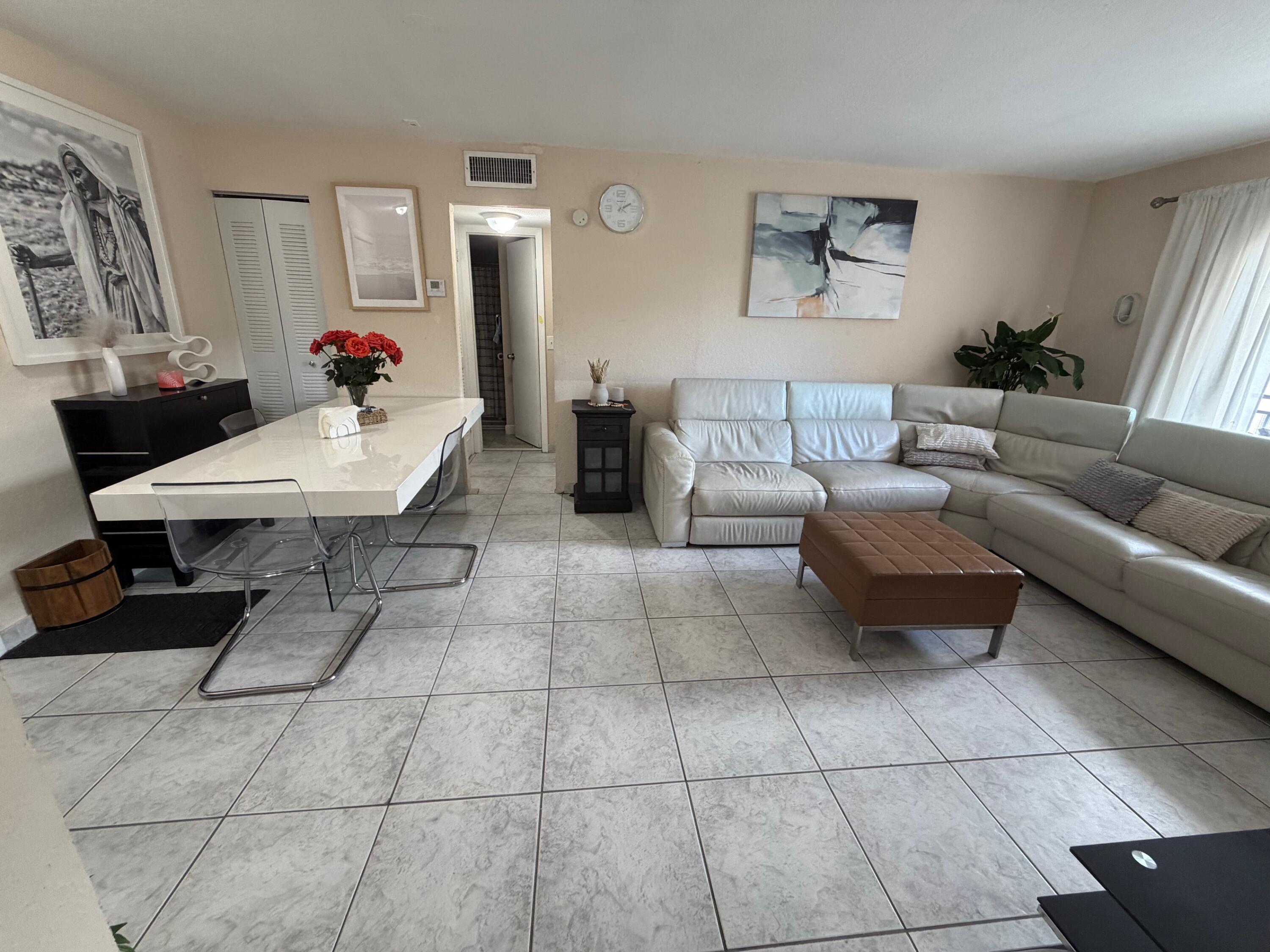 4841 Northwest 7th Street, Unit 3084 Miami, FL 33126 - Photo 19 of 29 a living room with furniture and a potted plant