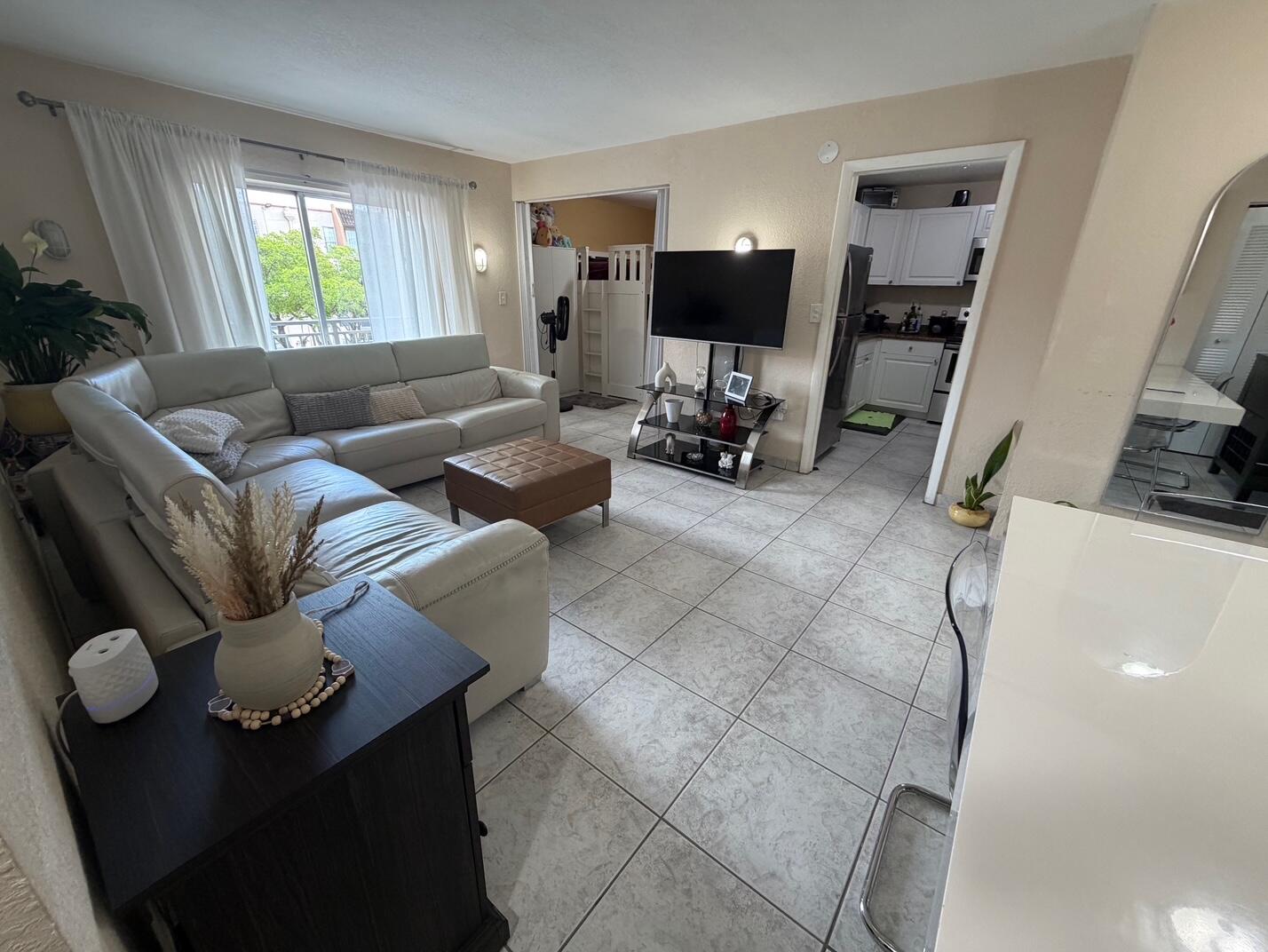 4841 Northwest 7th Street, Unit 3084 Miami, FL 33126 - Photo 20 of 29 a living room with furniture and a flat screen tv