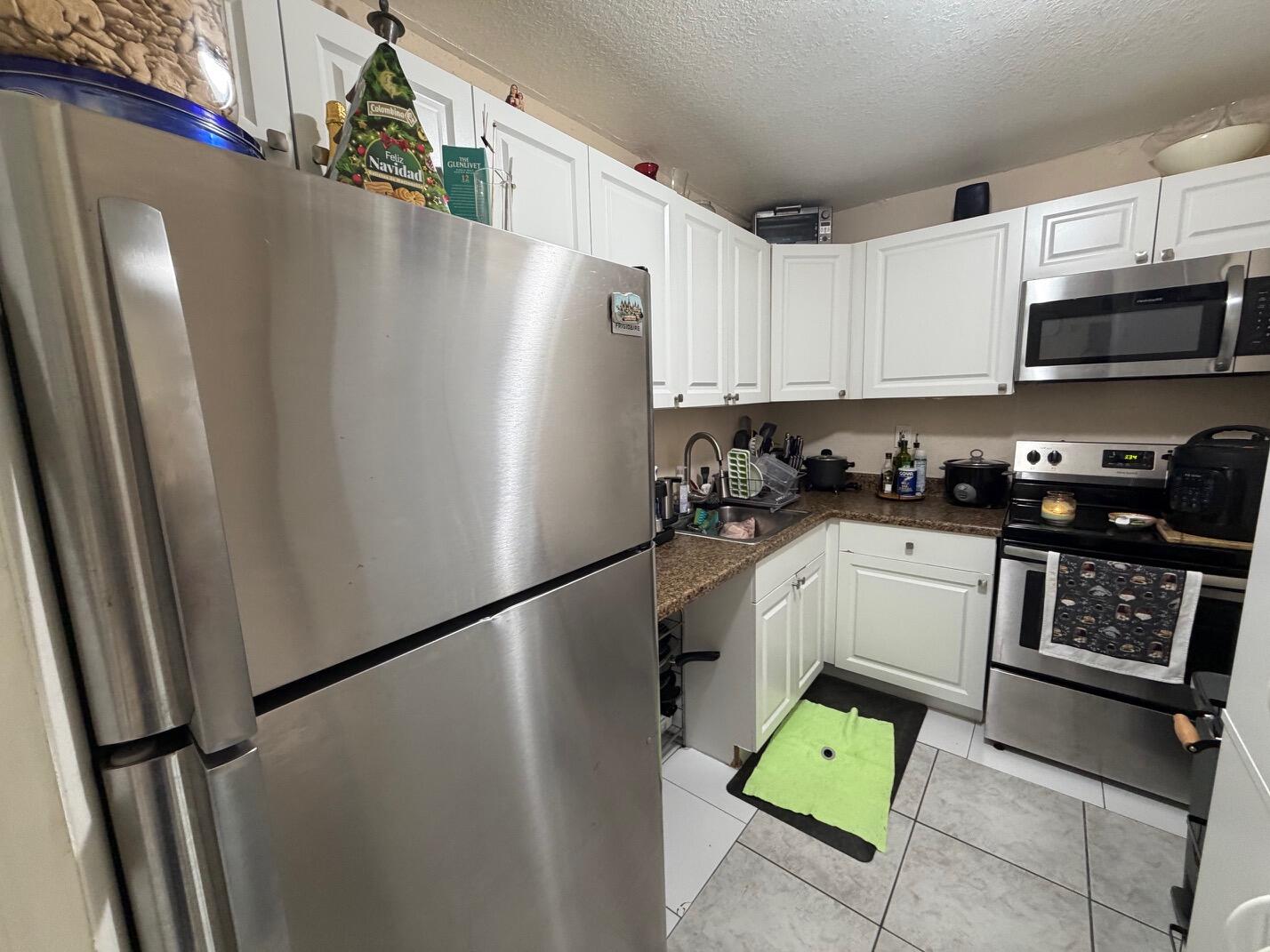 4841 Northwest 7th Street, Unit 3084 Miami, FL 33126 - Photo 2 of 29 a kitchen with stainless steel appliances a refrigerator a stove a sink and a refrigerator