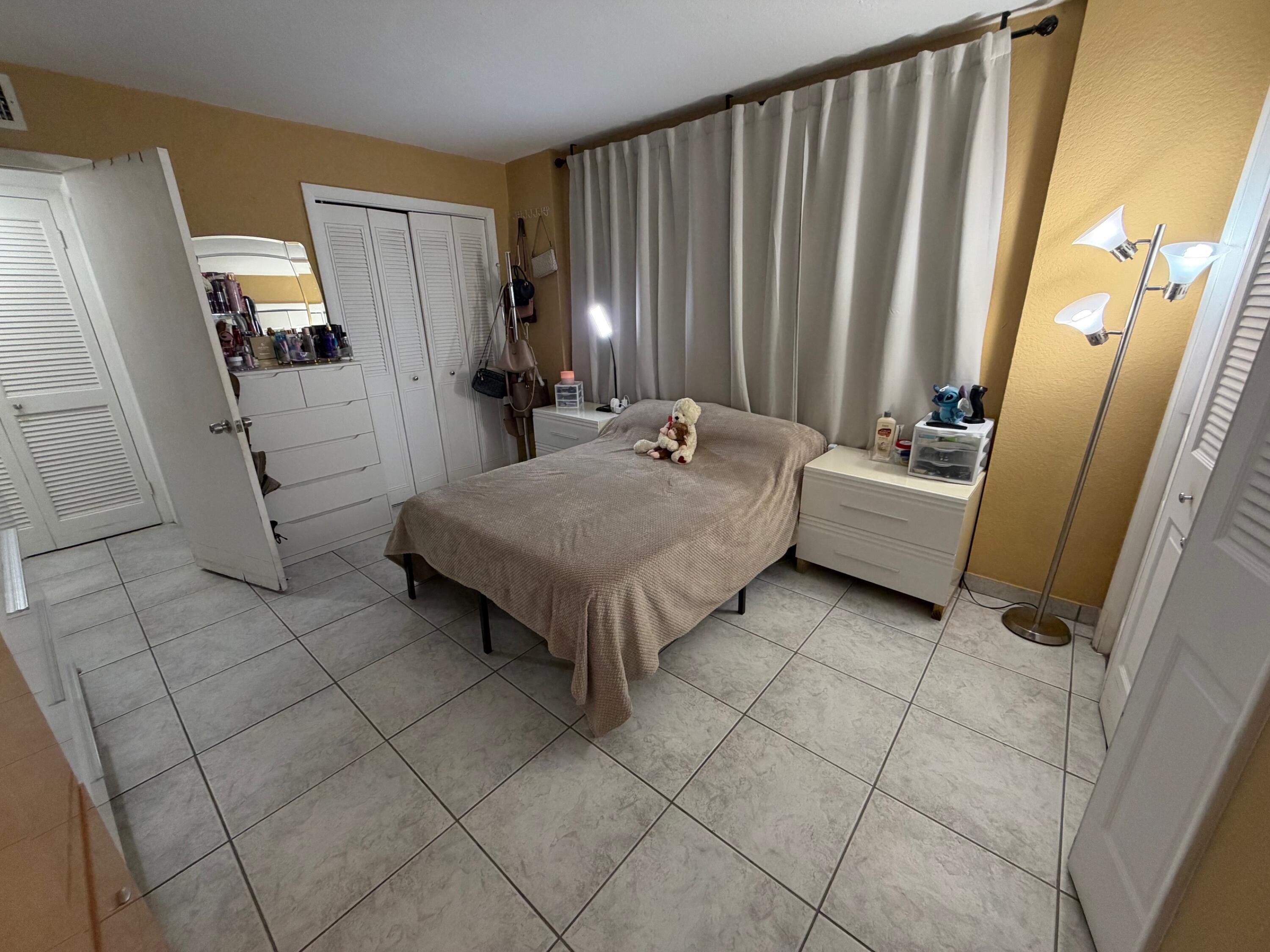 4841 Northwest 7th Street, Unit 3084 Miami, FL 33126 - Photo 23 of 29 a living room with furniture and a refrigerator