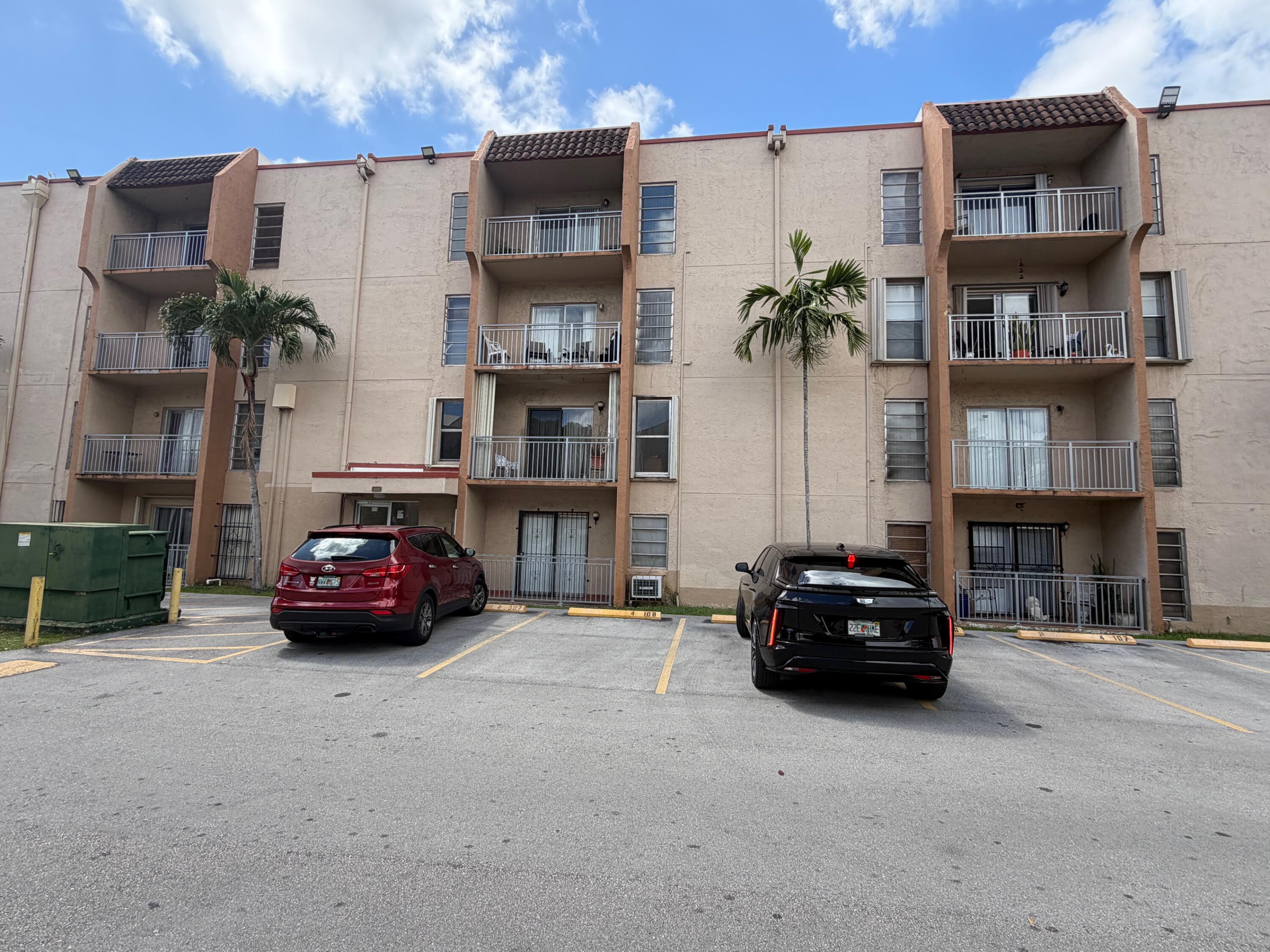 4841 Northwest 7th Street, Unit 3084 Miami, FL 33126 - Photo 27 of 29 a car parked in front of a building
