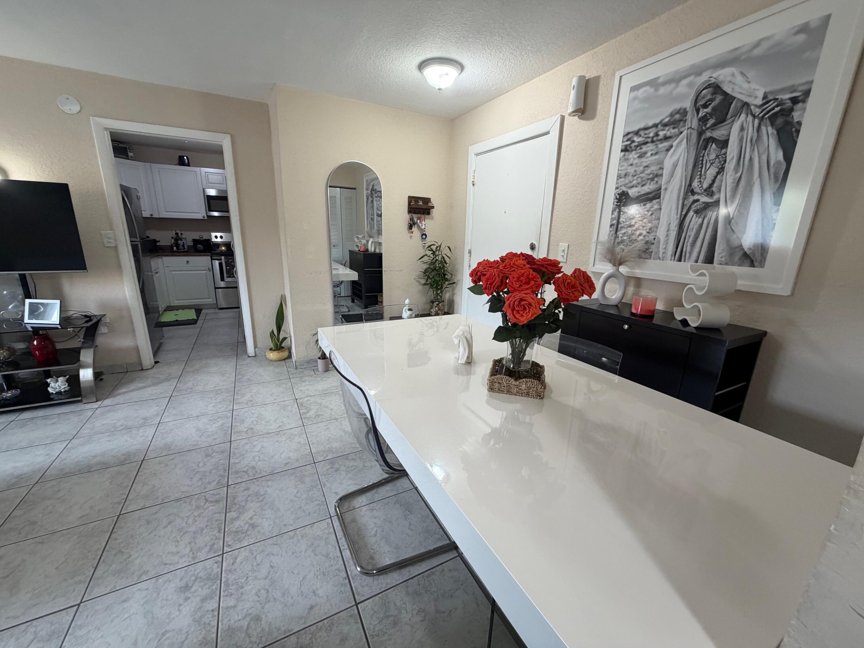 4841 Northwest 7th Street, Unit 3084 Miami, FL 33126 - Photo 3 of 29 a living room with furniture and a chandelier