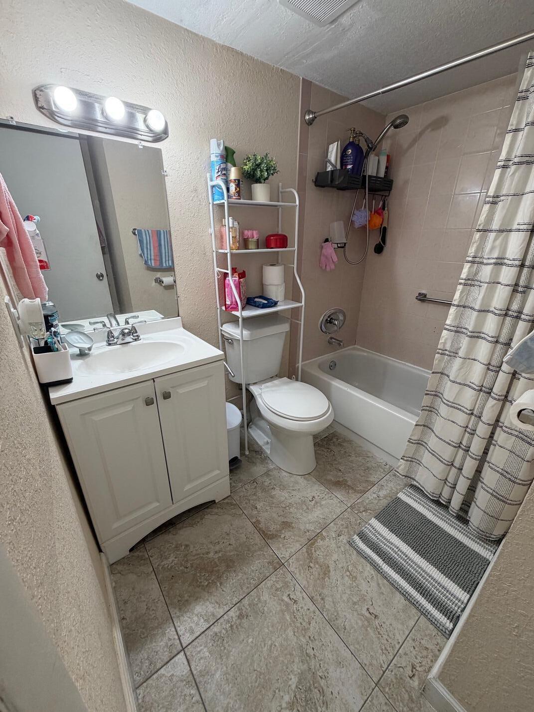 4841 Northwest 7th Street, Unit 3084 Miami, FL 33126 - Photo 5 of 29 a bathroom with a sink toilet and shower