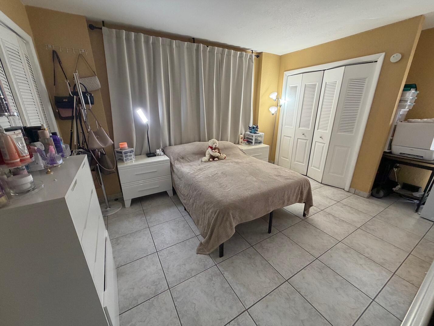 4841 Northwest 7th Street, Unit 3084 Miami, FL 33126 - Photo 6 of 29 a bath room with a bed and a couch