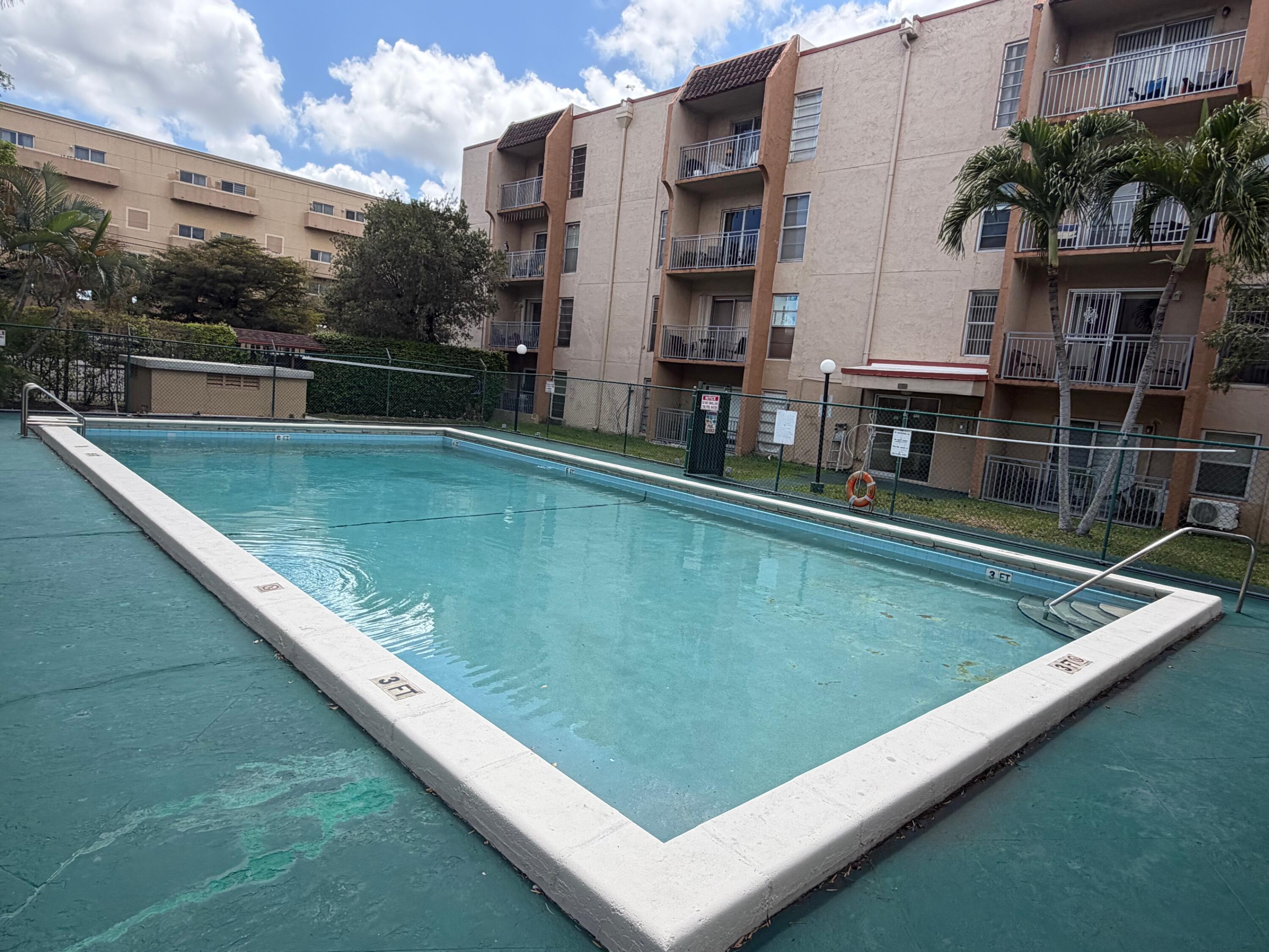 4841 Northwest 7th Street, Unit 3084 Miami, FL 33126 - Photo 8 of 29 a view of a swimming pool with a bench