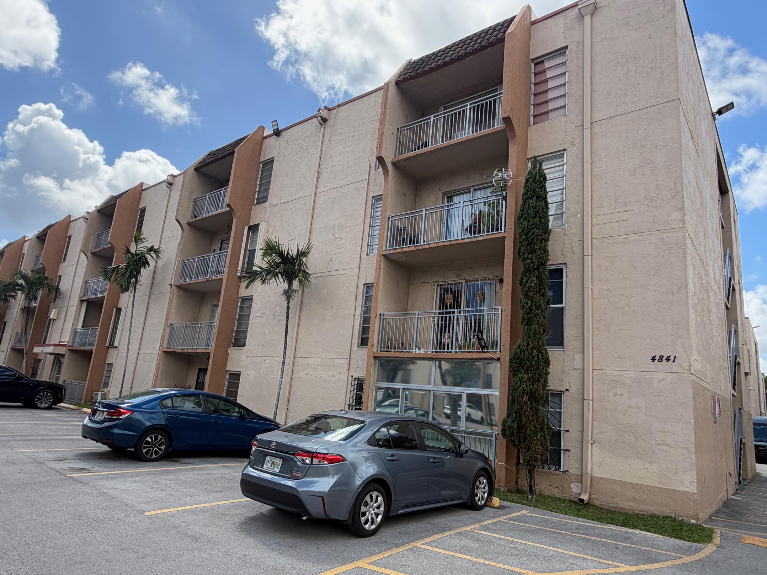 4841 Northwest 7th Street, Unit 3084 Miami, FL 33126 - Photo 9 of 29 a car parked in front of a building