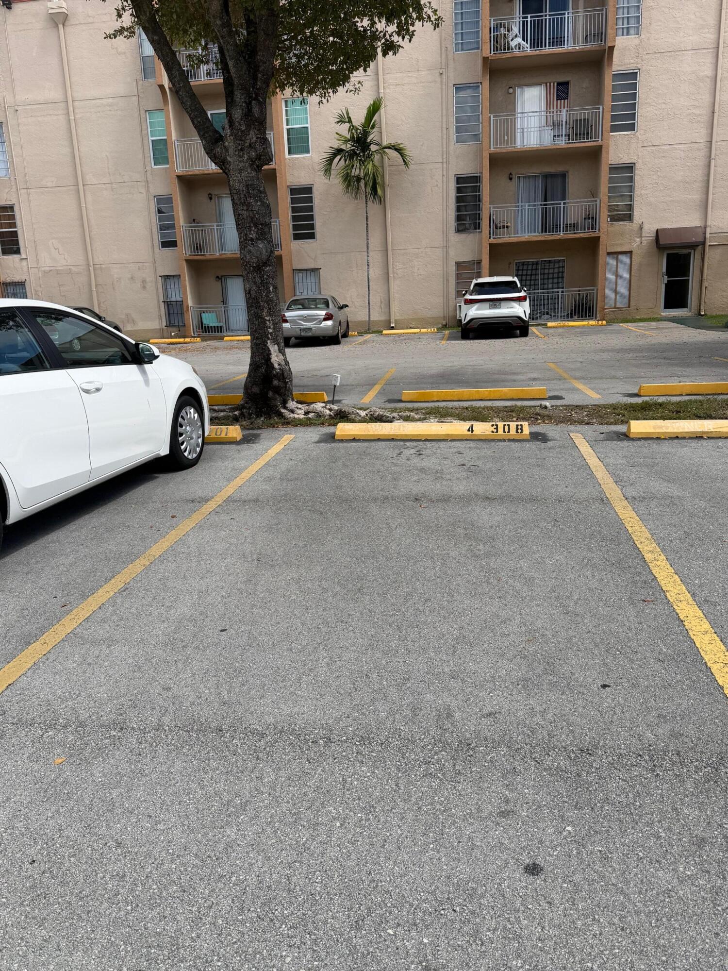 4841 Northwest 7th Street, Unit 3084 Miami, FL 33126 - Photo 10 of 29 a view of parking with cars parked