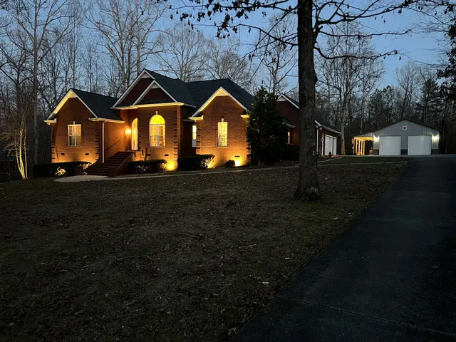 a front view of a house with yard and green space