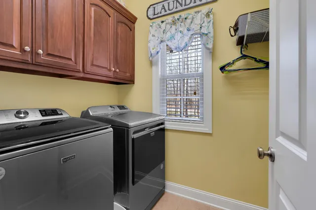 a spacious en suite bathroom with a double vanity sink and a large mirror