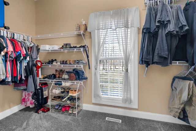 a bedroom with a bed a flat screen tv and dresser