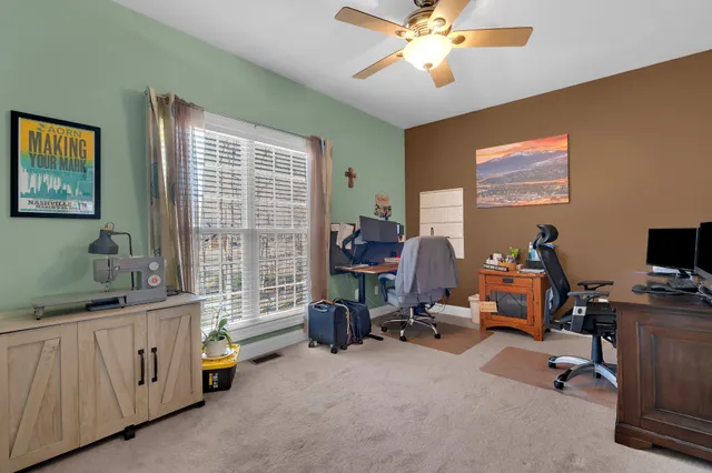 a living room with furniture and large windows