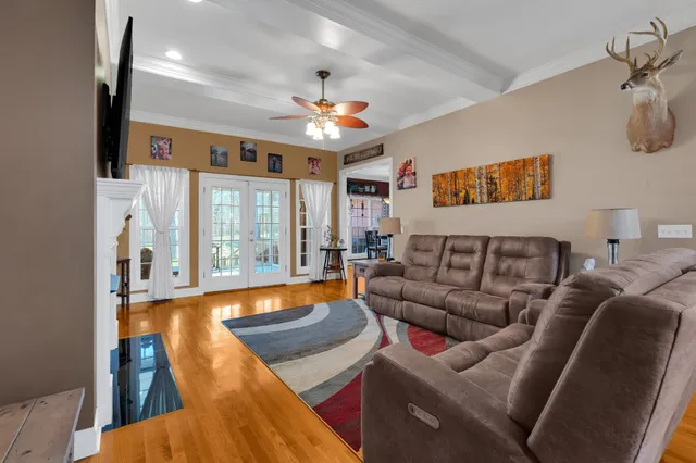 a living room with furniture fireplace and a chandelier