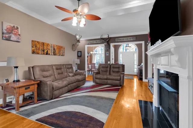 a living room with furniture a flat screen tv and a fireplace