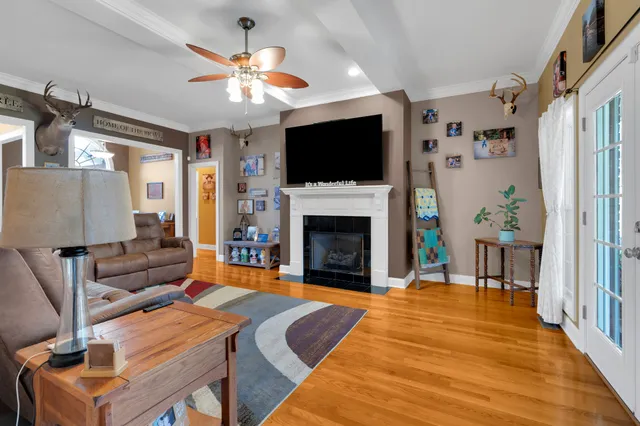 a living room with furniture a flat screen tv and a fireplace