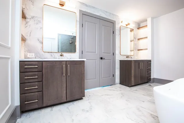 a bathroom with a sink vanity and mirror