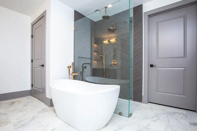 a view of a bathroom with a tub and shower