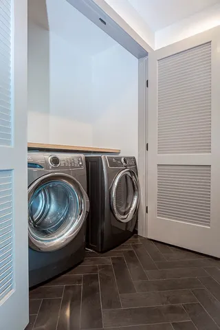 a utility room with washing machine and washer