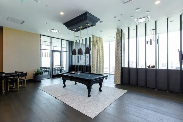 a kitchen with a table chairs refrigerator and microwave